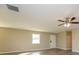 Bright living room featuring a ceiling fan and clean, neutral-colored walls at 430 Birch Se Ln, Conyers, GA 30094