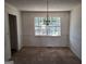 Cozy dining room with carpet and natural light through a large window at 7582 Carlisle Dr, Jonesboro, GA 30236