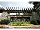 Community entrance to The Canoe Club, featuring a stone structure with lush greenery and landscaping at 505 Discovery Lake Dr # 405, Fayetteville, GA 30215