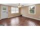 This bedroom features wood floors and a view of the backyard from the windows at 3 Ridge Dr, Hampton, GA 30228