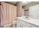 Well-lit bathroom with a shower/tub, and white cabinets at 1685 Tabor Dr, Marietta, GA 30062