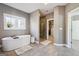 Bright bathroom with a glass shower, soaking tub, and walk-in closet at 1685 Tabor Dr, Marietta, GA 30062