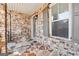 Covered front porch featuring stone veneer wall, flagstone floor, exterior light, and trimmed windows at 1685 Tabor Dr, Marietta, GA 30062
