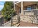 Inviting covered front porch with stone pillars and railing, steps, and black wrought iron railing at 1685 Tabor Dr, Marietta, GA 30062