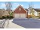 Detached two-car garage with overhead door and adjacent backyard at 1685 Tabor Dr, Marietta, GA 30062