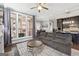 Open concept living room and kitchen with modern ceiling fan, luxury vinyl floors and natural lighting at 1685 Tabor Dr, Marietta, GA 30062