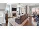 Inviting living room with modern ceiling fan, fireplace, hardwood floors, and large windows at 1685 Tabor Dr, Marietta, GA 30062
