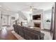 Cozy living room featuring a fireplace, ceiling fan, hardwood floors, and staircase at 1685 Tabor Dr, Marietta, GA 30062