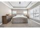 Spacious main bedroom with tray ceiling, neutral gray walls, and lots of natural light at 1685 Tabor Dr, Marietta, GA 30062