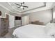 Large main bedroom with a tray ceiling, neutral gray walls, and a ceiling fan at 1685 Tabor Dr, Marietta, GA 30062
