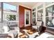 Relaxing screened-in porch with wood floors, comfortable seating, and plenty of natural light at 1685 Tabor Dr, Marietta, GA 30062