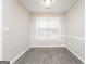 Bright dining room features chair rail molding, neutral paint, wood-look flooring and a large window at 310 Alcovy Way, Covington, GA 30014