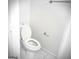 Bright bathroom featuring a white toilet with tiled floors and neutral walls at 8053 Woodlake Dr, Riverdale, GA 30274