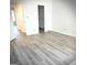 Bright bedroom with light gray hard flooring and a walk-in closet provides ample storage at 8053 Woodlake Dr, Riverdale, GA 30274