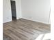 Empty bedroom with modern flooring and a closet at 8053 Woodlake Dr, Riverdale, GA 30274