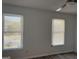 Bedroom featuring neutral walls, two bright windows, and a ceiling fan at 8053 Woodlake Dr, Riverdale, GA 30274