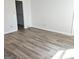 Bright bedroom with light gray hard flooring and a walk-in closet provides ample storage at 8053 Woodlake Dr, Riverdale, GA 30274