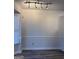 Bright dining room with track lighting, wainscoting and wood-look flooring at 8053 Woodlake Dr, Riverdale, GA 30274