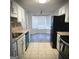 Eat-in kitchen with granite countertops, stainless appliances and a view to the breakfast nook at 8053 Woodlake Dr, Riverdale, GA 30274