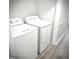 Bright laundry room featuring a white washer and dryer at 8053 Woodlake Dr, Riverdale, GA 30274