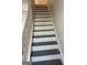 Painted staircase with white trim at 8053 Woodlake Dr, Riverdale, GA 30274