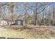 Spacious backyard features a shed, bordered by a fence and mature trees offering privacy at 742 Wilkes Dr, Loganville, GA 30052