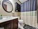 A cozy bathroom with a dark wood vanity, white sink and a framed mirror at 230 Mapledale Trl, Sharpsburg, GA 30277