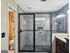 A modern bathroom with a tiled stand up shower and a glass door at 230 Mapledale Trl, Sharpsburg, GA 30277