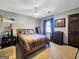A bedroom with neutral walls, ceiling fan, and wood frame bed at 230 Mapledale Trl, Sharpsburg, GA 30277