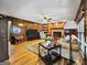 Inviting living room featuring wood-paneled walls, a cozy brick fireplace, hardwood floors, and ample seating for relaxation at 230 Mapledale Trl, Sharpsburg, GA 30277