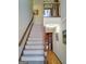 Carpeted staircase with wooden banisters leading to the upper level of the home, offering a glimpse of the interior at 230 Mapledale Trl, Sharpsburg, GA 30277