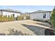 View of a large backyard surrounded by trees and featuring a lawn and well-manicured shrubs at 132 Platinum Rdg, Sharpsburg, GA 30277
