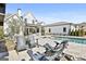 View of backyard showing the pool, a large covered veranda, and Adirondack chairs around an outdoor fireplace at 132 Platinum Rdg, Sharpsburg, GA 30277