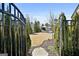 View through a gate to the backyard showing the pool and lounge chairs at 132 Platinum Rdg, Sharpsburg, GA 30277