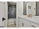 Chic bathroom with white vanity, gold fixtures, and a stylish gray tiled shower at 132 Platinum Rdg, Sharpsburg, GA 30277