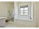 Elegant bathroom featuring a soaking tub, tiled shower with glass door, and bright window at 132 Platinum Rdg, Sharpsburg, GA 30277