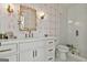 Modern bathroom featuring a white vanity, decorative mirror, and glass-enclosed shower at 132 Platinum Rdg, Sharpsburg, GA 30277