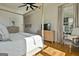 Light-filled bedroom with a four-poster bed, hardwood floors, a ceiling fan, and ample natural light at 132 Platinum Rdg, Sharpsburg, GA 30277