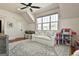 Bright bonus room featuring a white sofa, play area, and natural light from a large window at 132 Platinum Rdg, Sharpsburg, GA 30277