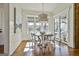 Bright dining area with a rustic chandelier, modern art and a view to the outside patio at 132 Platinum Rdg, Sharpsburg, GA 30277