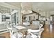 Bright dining area featuring an elegant chandelier, white chairs, and an open floor plan with hardwood floors at 132 Platinum Rdg, Sharpsburg, GA 30277
