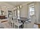 Open dining space with stylish wallpaper, hardwood floors, and a modern chandelier for an elegant look at 132 Platinum Rdg, Sharpsburg, GA 30277