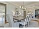 Spacious dining room boasting an open floor plan, a dining table set for eight, and stylish furnishings at 132 Platinum Rdg, Sharpsburg, GA 30277