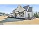 Stunning home with stone accents, black trim, and a covered porch, perfect for relaxing outdoors at 132 Platinum Rdg, Sharpsburg, GA 30277