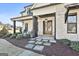 Inviting covered porch with rocking chairs, stone accents, and warm lighting at 132 Platinum Rdg, Sharpsburg, GA 30277