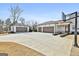 Ample parking space with multiple garage doors and a basketball hoop, enhancing the property's appeal at 132 Platinum Rdg, Sharpsburg, GA 30277
