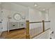 Upper hallway featuring a decorative cabinet and railing overlooking the lower level at 132 Platinum Rdg, Sharpsburg, GA 30277