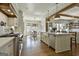 View of kitchen with stainless appliances and a large island sink which overlooks the dining and living rooms at 132 Platinum Rdg, Sharpsburg, GA 30277