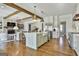 Open floor plan view of kitchen and living room featuring a large kitchen island and a stone fireplace at 132 Platinum Rdg, Sharpsburg, GA 30277