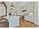 Spacious kitchen with an island, stainless steel appliances, custom range hood, and white cabinetry at 132 Platinum Rdg, Sharpsburg, GA 30277